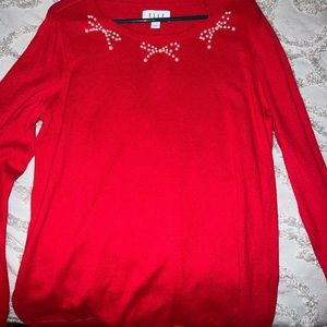 red sweater with pearl bow details